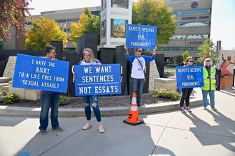 Demonstrators holding signs at Houdini Plaza in Appleton in support of the Cornell University Jane Doe