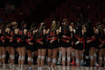 Carthage women's volleyball team in a huddle