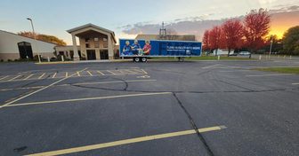 A Feed My Starving Children semi-trailer outside the packing event venue in Eau Claire at sunset