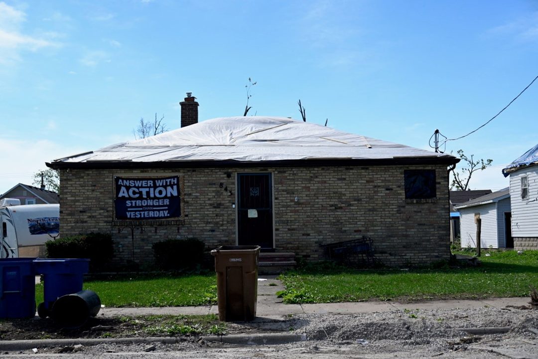 A home with a tarped roof after tornado damage in the Fox Valley