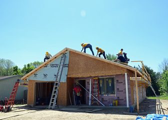 Volunteers building a Habitat for Humanity house
