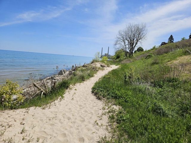 The Lake Michigan shoreline near Sheboygan on a clear day, with a sandy path along the water