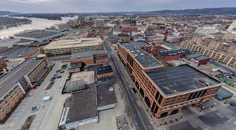 Downtown La Crosse from above, with the Mississippi River and bluffs in the distance