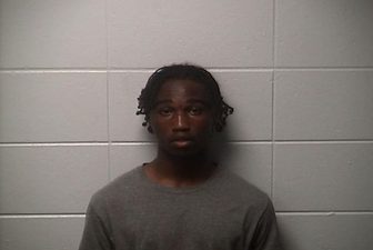 Booking photo of Javarius Hurd in a gray shirt against a cinder block wall