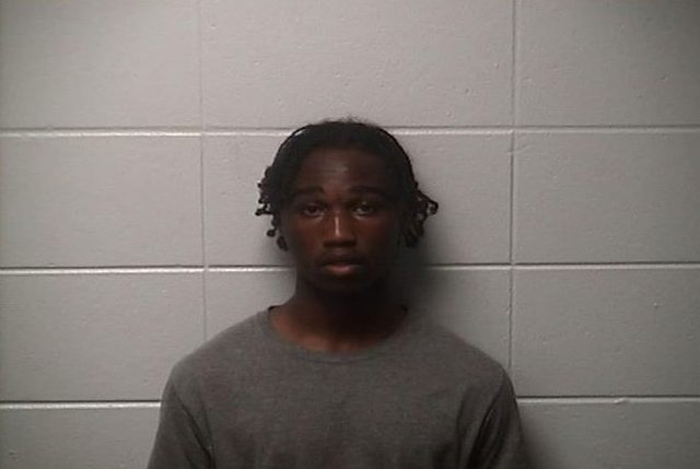 Booking photo of Javarius Hurd in a gray shirt against a cinder block wall