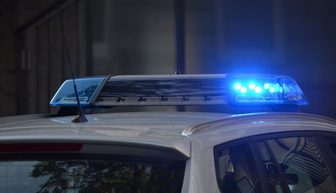 Police vehicle light bar with blue lights flashing