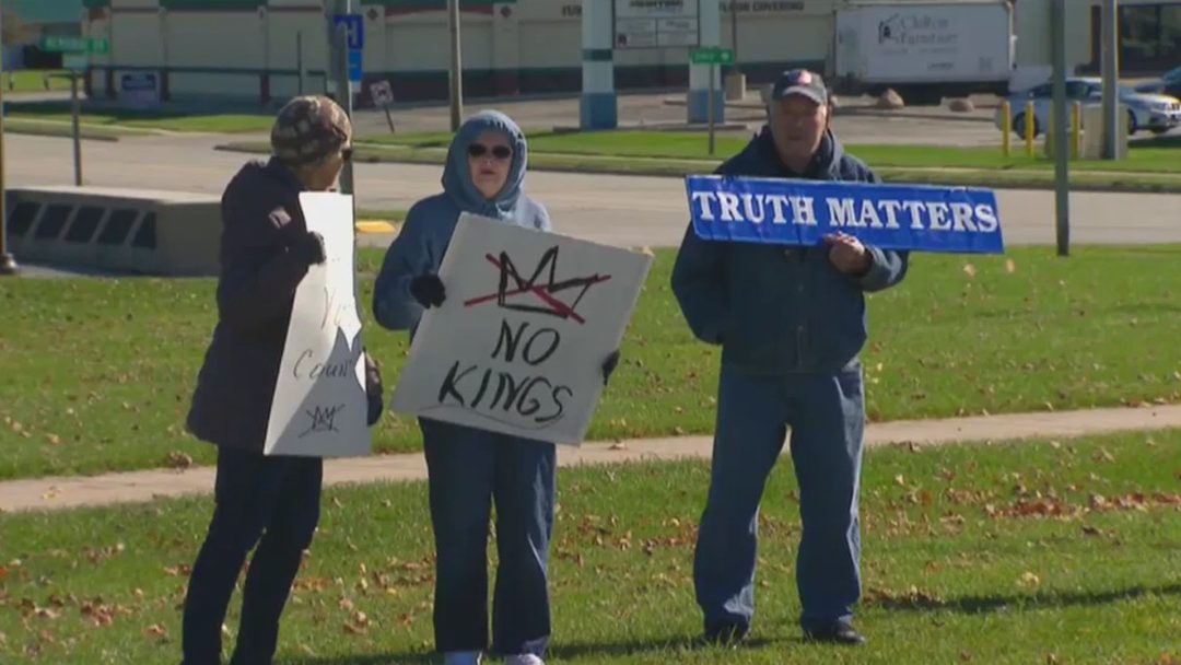 'No Kings' protesters in Chilton on Saturday, Oct. 17, 2026, holding signs including one reading 'No Kings' and another 'Truth Matters'