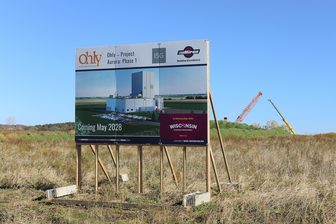 Project sign for Ohly's Project Aurora Phase 1 at the Eau Claire construction site, with cranes in the background
