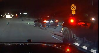 Squad camera view of a Pleasant Prairie police Grappler deployment at night