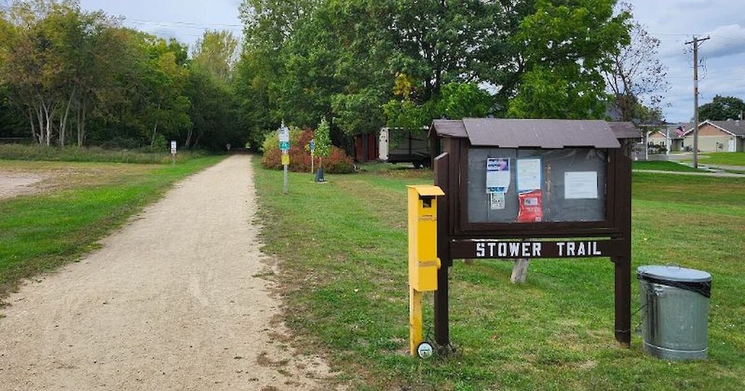 The Stower Trail trailhead, with a gravel path and an information kiosk