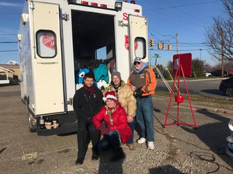 Volunteers with donated coats at a Salvation Army coat drive