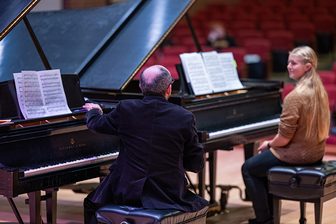 Guest artist Yakov Kasman coaches a participant at a piano during the 2025 UW-River Falls Keyboard Festival