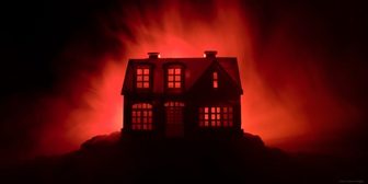 Silhouette of a house against a red background with lit windows, promoting horror trivia at the Marathon County Public Library