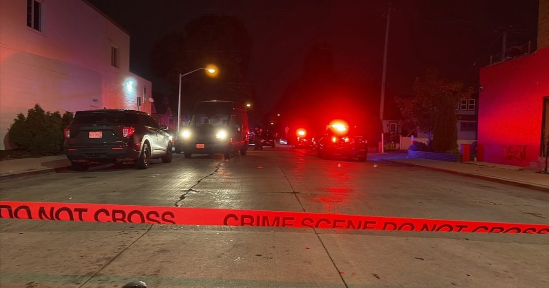 Police vehicles and crime scene tape near South 71st Street and West Grant Street in West Allis at night